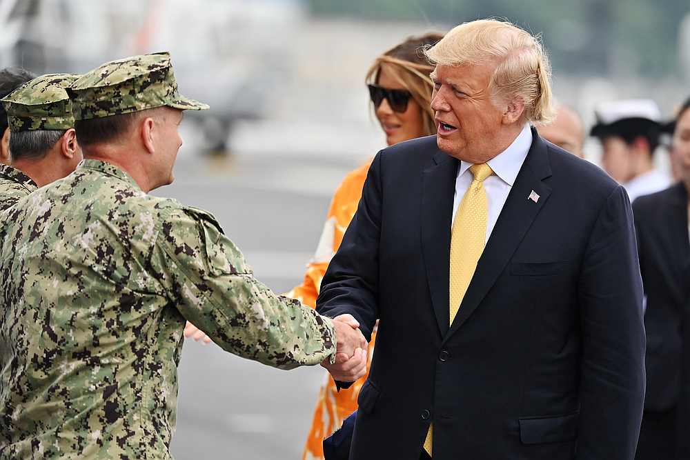 US President Donald Trump and First Lady Melania Trump greet US naval personnel as they arrive onboard Japan's largest warship Kaga in Yokosuka, Japan May 28, 2019. u00e2u20acu201d Charly Triballeau/Pool pic via  Reuters