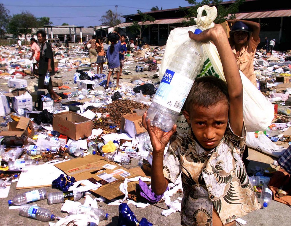 East Timorese collect plastic containers and leftovers at a garbage dump in Dili September 27. u00e2u20acu201d Reuters pic 