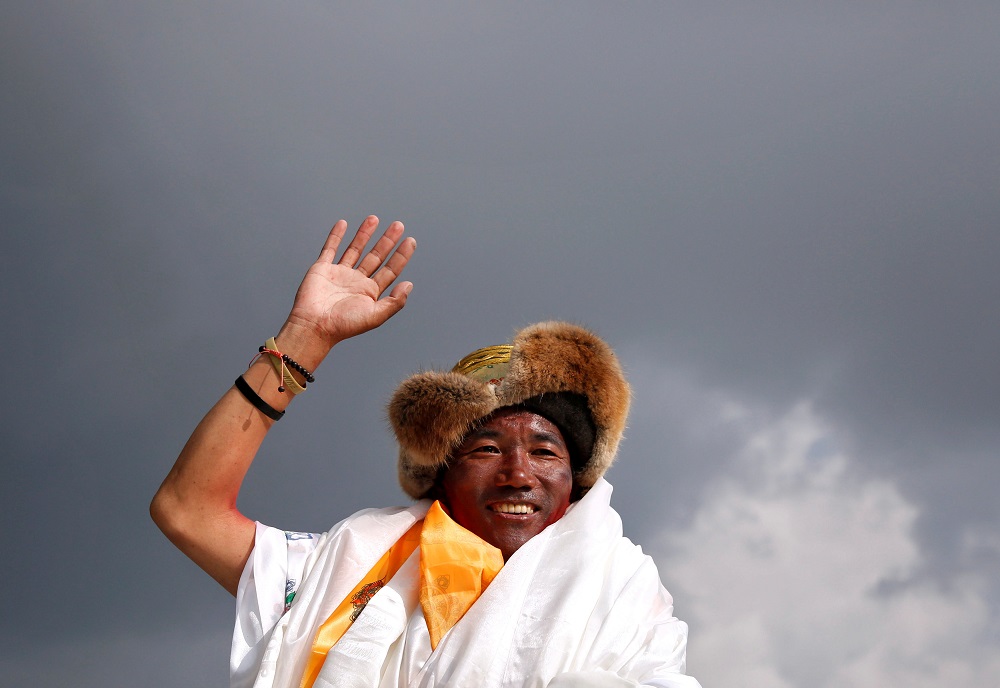 Kami Rita Sherpa, 48, a Nepali mountaineer waves towards media personnel after climbing Mount Everest for a 22nd time, creating a new record for the most summits of the worldu00e2u20acu2122s highest mountain, in Kathmandu, Nepal May 20, 2018. u00e2u20acu201d Reuters pic