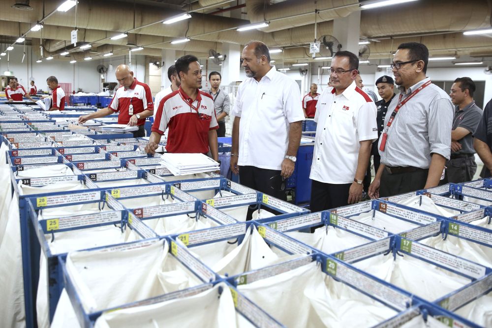 Communications and Multimedia Minister Gobind Singh Deo (centre) is pictured during a visit to Pos Malaysiau00e2u20acu2122s National Mail Centre in Shah Alam May 15, 2019. u00e2u20acu201d Picture by Yusof Mat Isann