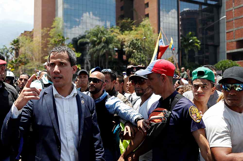 Venezuelan opposition leader Juan Guaido, who many nations have recognised as the country's rightful interim ruler, walks with supporters in Caracas, Venezuela April 30, 2019. u00e2u20acu201d Reuters pic