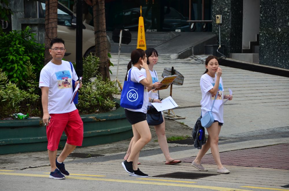 Participants attempt to decode their clues at a checkpoint during the treasure hunt. — Picture courtesy of Hospis Malaysia