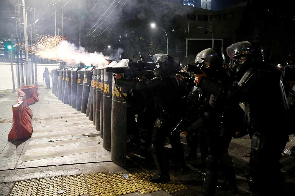 Mobile brigade (Brimob) police officers aim tear gas weapons during a clash with locals in Jakarta, Indonesia May 22, 2019. u00e2u20acu201d Reuters pic
