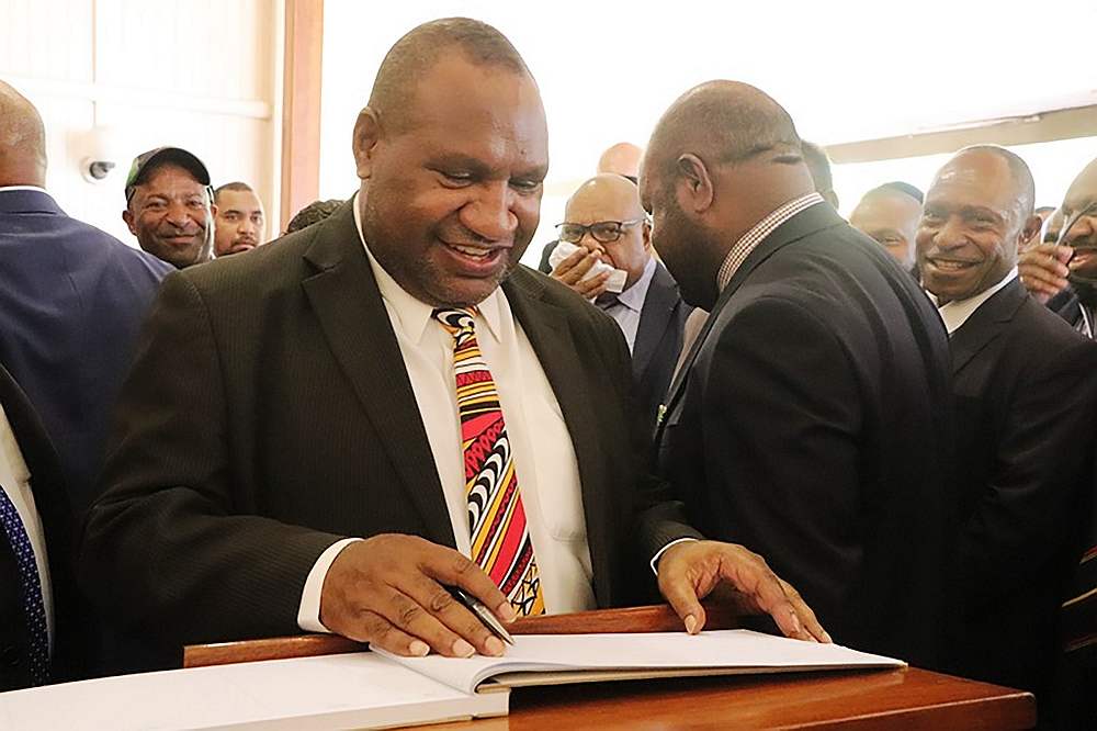Papua New Guinea's new prime minister, James Marape, signs the visitors' book at the house of Governor-General Bob Dadae in Port Moresby May 30, 2019. u00e2u20acu201d AFP pic