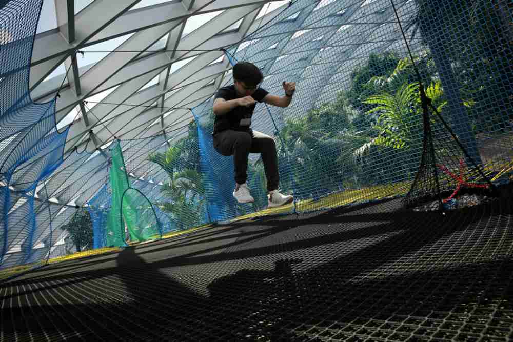 A visitor jumps on a giant bouncing net, during the media preview of Canopy Park and Changi Experience Studio at Jewel Changi Airport on May 30, 2019. u00e2u20acu2022 Picture by Nuria Ling via TODAY