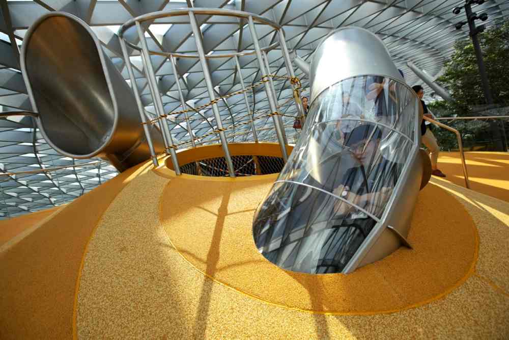 A visitor takes a ride down the Discovery Slides, a playscape as well as art sculpture at the Canopy Park. ― Picture by Nuria Ling via TODAY