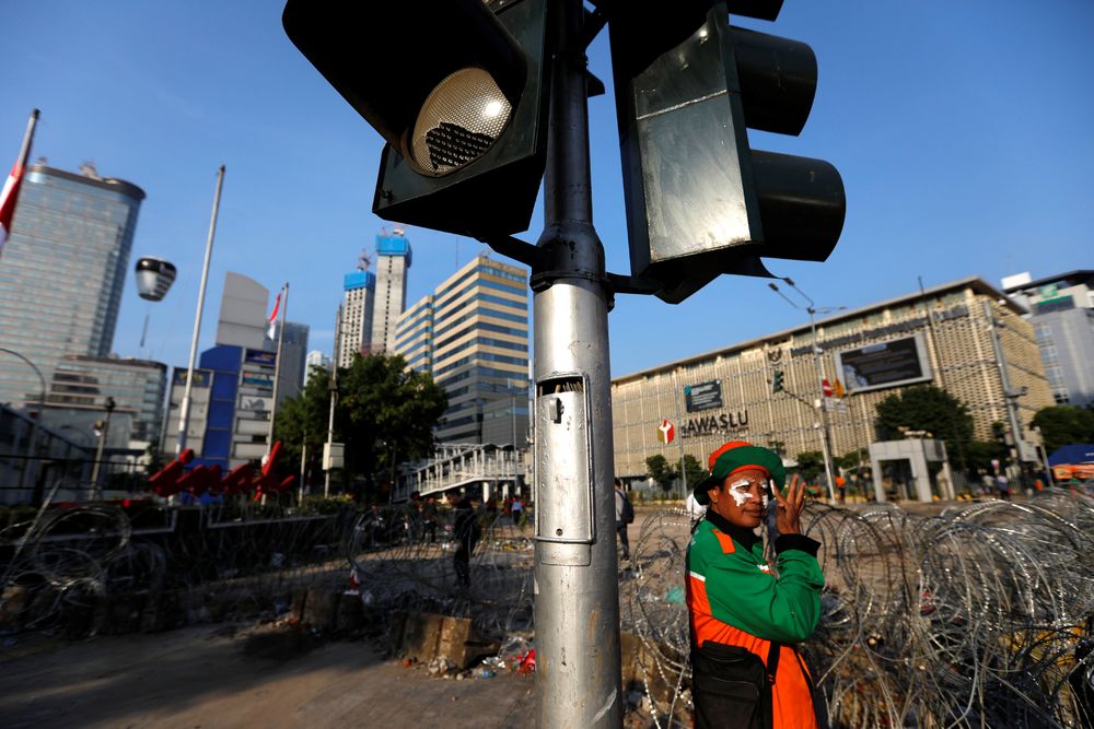 A worker cleans trash from the area after a riot outside Indonesiau00e2u20acu2122s Election Supervisory Agency (Bawaslu) headquarters following the announcement of presidential election results in Jakarta, May 23, 2019. u00e2u20acu201d Reuters pic