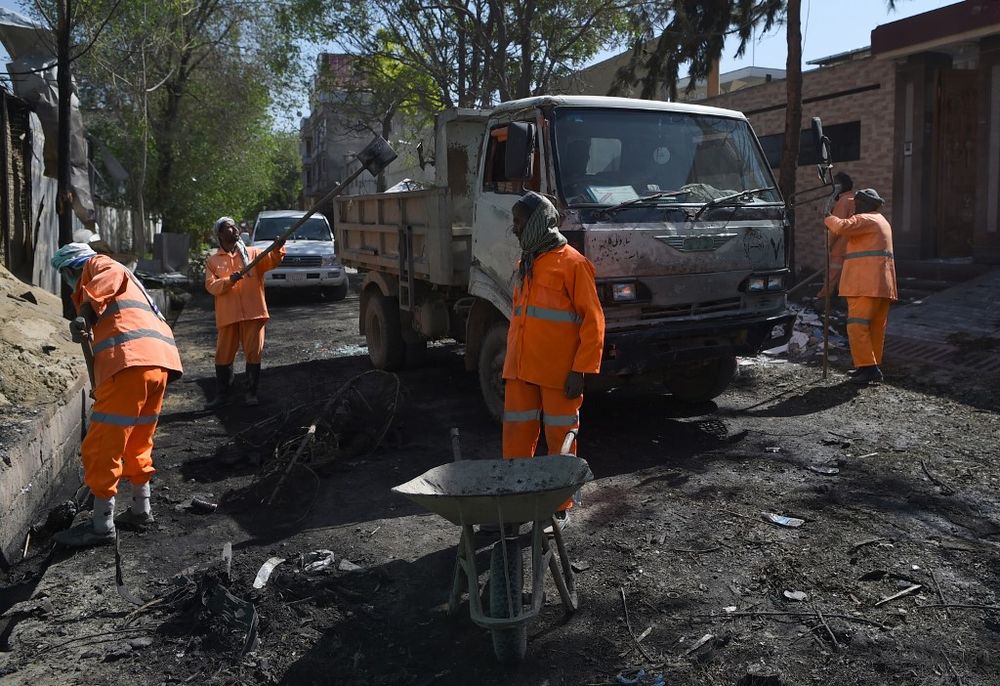 Afghan municipality workers work to clear up the site of an attack by Taliban militants, a day after the assault on a compound housing an international aid organisation, in Kabul on May 9, 2019. u00e2u20acu201d AFP pic