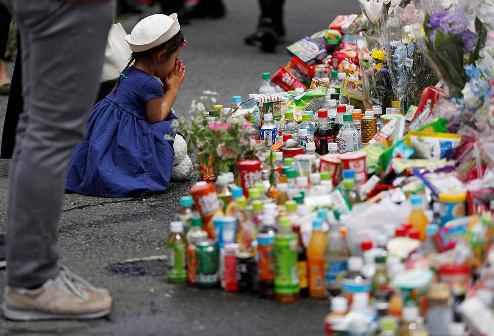 A girl prays to mourn victims as she offers flowers at the site where a stabbing occured in Kawasaki, Japan May 29, 2019. u00e2u20acu201d Reuters pic