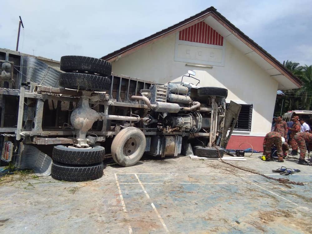 The lorry after it crashed into a community hall along Jalan Ahmad in Kampung Baru Pagoh at Lenga Batu 23, Pagoh today. u00e2u20acu201d Picture courtesy of the Johor Fire and Rescue Department