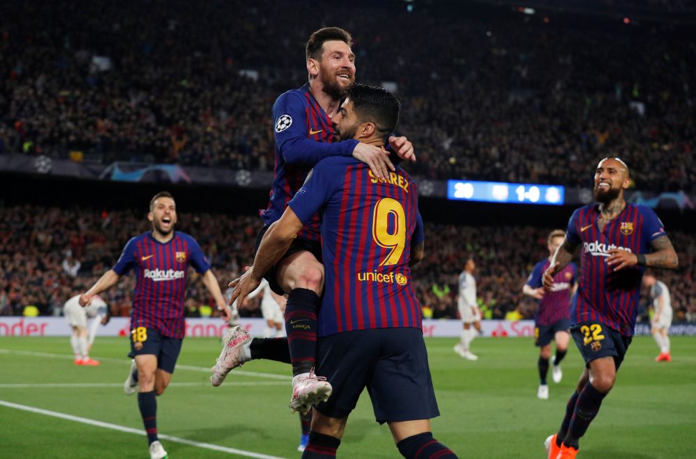 Barcelona's Lionel Messi celebrates scoring against Liverpool with Luis Suarez and team mates. u00e2u20acu201d Reuters pic