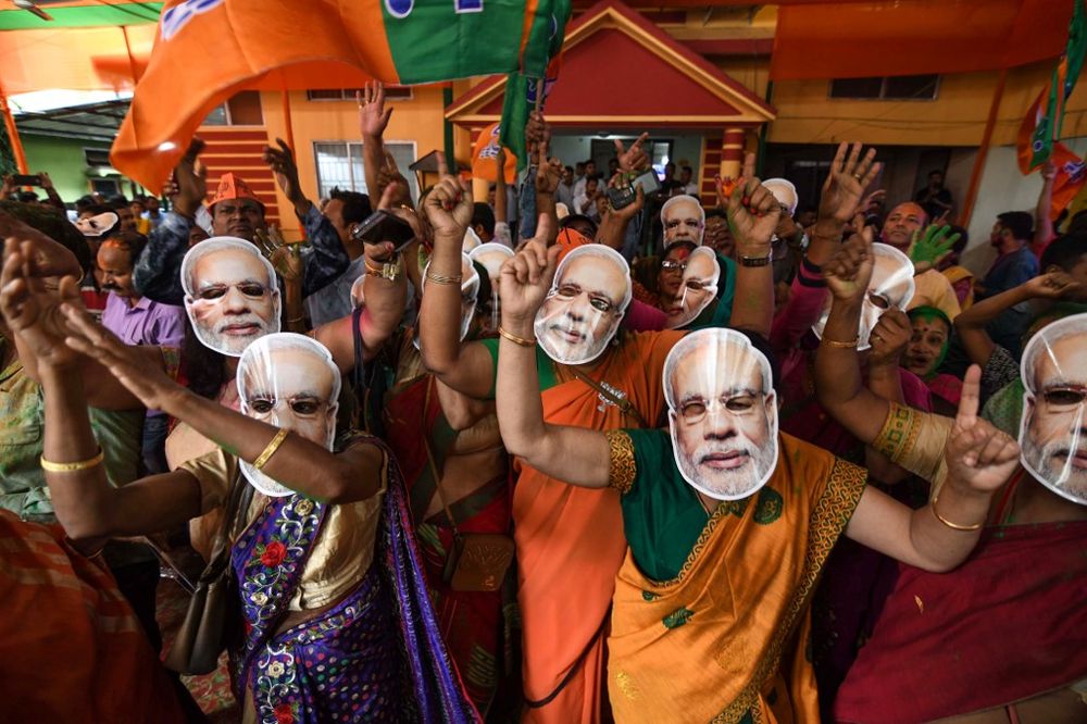 Indian Bharatiya Janata Party (BJP) supporters wearing masks of Indian Prime Minister Narendra Modi dance as they celebrate on the vote results day for Indiau00e2u20acu2122s general election at BJP office in Guwahati on May 23, 2019. u00e2u20acu201d AFP pic