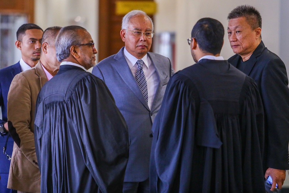 Datuk Seri Najib Razak chats with his lawyers at the Kuala Lumpur Court Complex May 29, 2019. — Picture by Hari Anggara