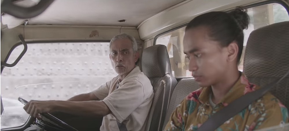 Pak Man scolds Amir for meddling with his things in his truck in a new Hari Raya themed short film PLUS. u00e2u20acu201d Screengrab via Youtube/PLUS TV