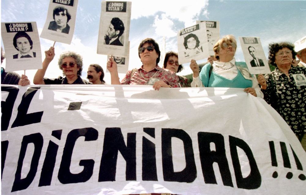 Relatives of disappeared prisoners asking for the whereabouts of their missed family members during a demonstration at the grounds of Colonia Dignidad near Parral, around 400km south of the Chilean capital Santiago, October 25, 1997. u00e2u20acu201d AFP pic