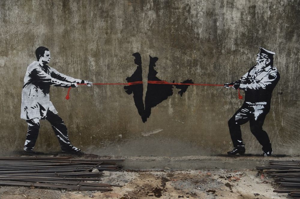 A wall graffiti depicting Indian National Congress (INC) party leader Rahul Gandhi (left) and Prime Minister Narendra Modi of Bharatiya Janata Party (BJP) in a tug of war over India is seen in Mumbai on April 28, 2019. u00e2u20acu201d AFP pic