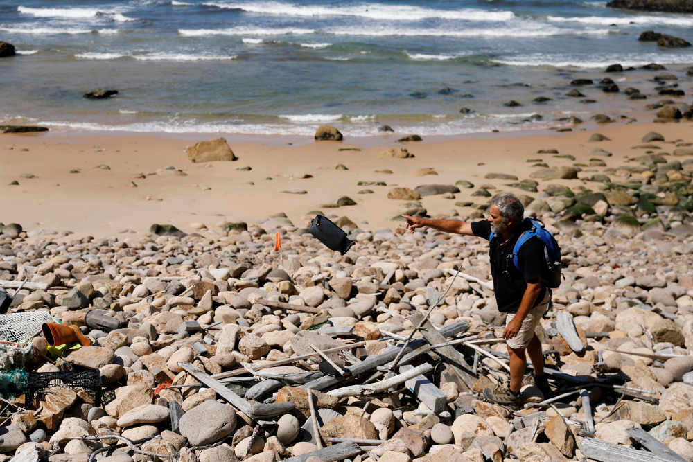 Miguel Lacerda, 62, collects trash at a beach at the coast near Sintra, Portugal May 22, 2019. u00e2u20acu201d Reuters pic