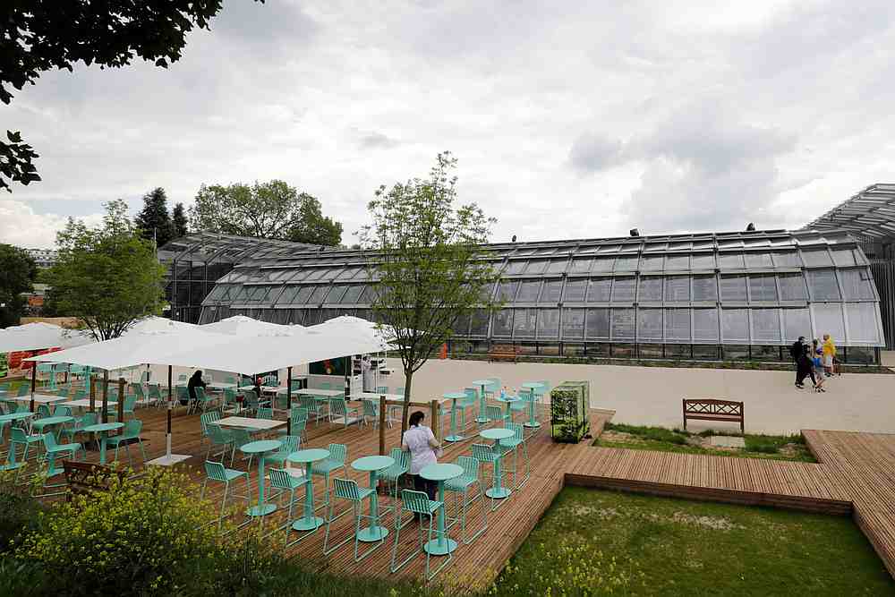 People walk outside the Simonne Mathieu court during the Roland Garros 2019 French Open tennis tournament in Paris May 25, 2019. u00e2u20acu201d AFP