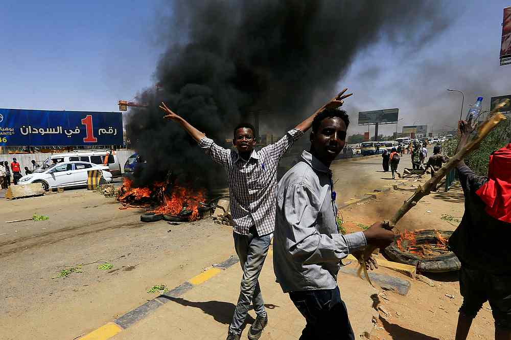 Sudanese protesters cheer as they burn tyres and barricade the road leading to al-Mek Nimir Bridge crossing over Blue Nile that links Khartoum North and Khartoum in Sudan May 13, 2019. u00e2u20acu201d Reuters pic