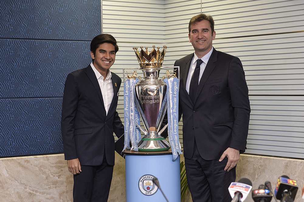 Youth and Sports Minister Syed Saddiq Abdul Rahman and Manchester City CEO Ferran Soriano pose for pictures with the Premier League trophy during a press conference in Putrajaya May 23, 2019. u00e2u20acu201d Picture by Miera Zulyana