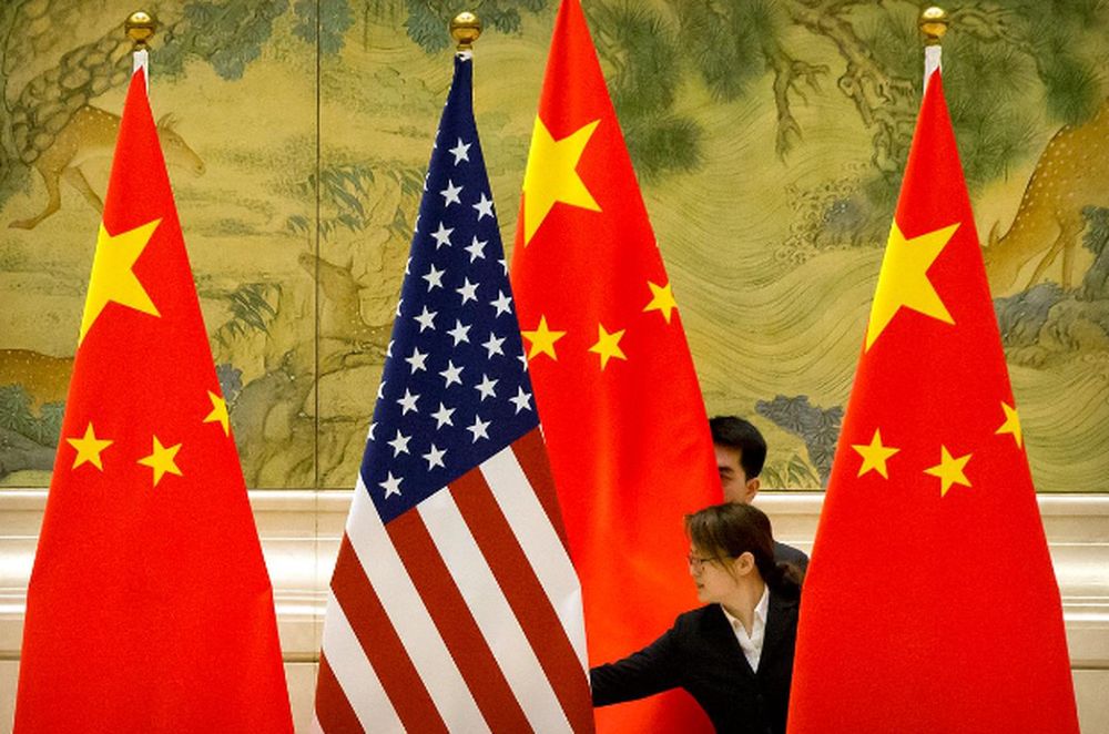 Chinese staffers adjust US and Chinese flags before the opening session of trade negotiations between US and Chinese trade representatives at the Diaoyutai State Guesthouse in Beijing, Feb. 14, 2019. u00e2u20acu201d Reuters pic