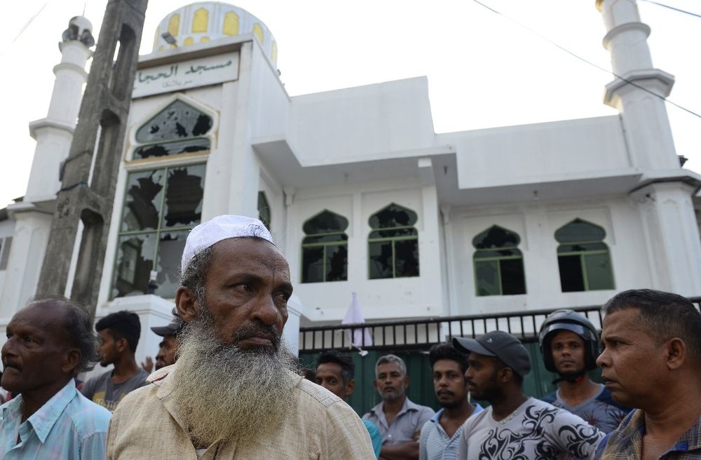 Muslim men stand in front of the damaged Jumha Mosque after a mob attack in Minuwangoda on May 14, 2019, north of the Sri Lankan capital Colombo. u00e2u20acu201d AFP pic