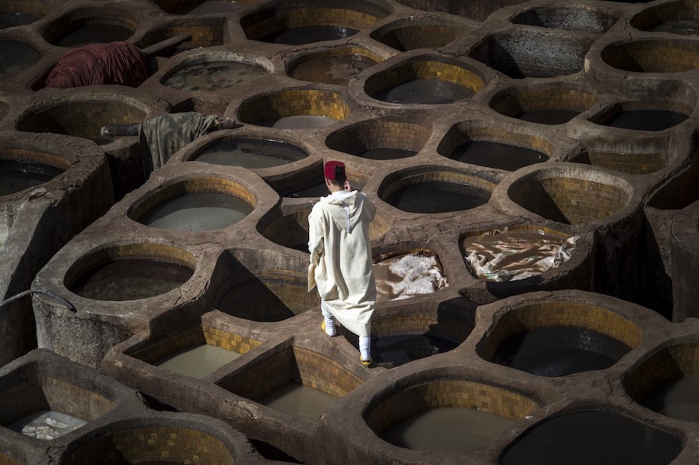 A Moroccan man walks in the tannery in the 9th century walled medina in the ancient city of Fez April 11, 2019. — AFP pic