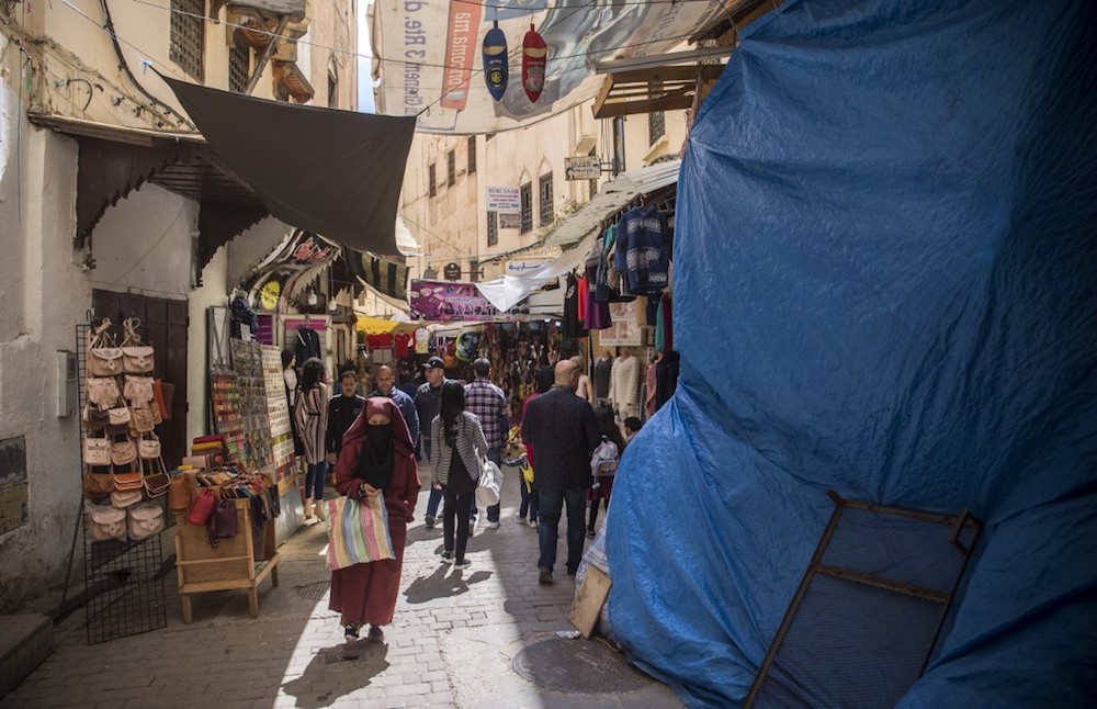 Tourists and locals walk in the 9th century walled medina in the ancient Moroccan city of Fez April 11, 2019. — AFP pic