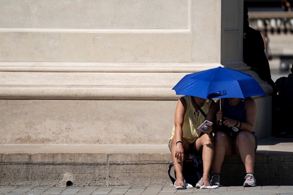 People use an umbrella to shelter from the sun near the Louvre Pyramid during a heatwave in Paris June 26, 2019. u00e2u20acu201d AFP pic