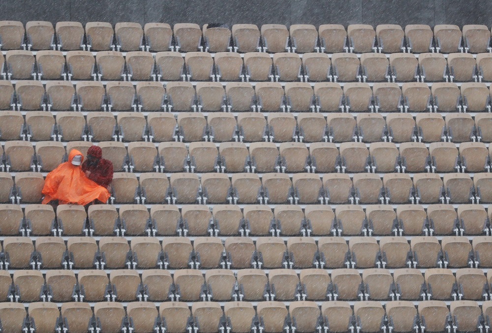 Spectators sit in the rain during quarterfinal match between Stanislas Wawrinka and Roger Federer in Paris June 4, 2019. u00e2u20acu201d Reuters pic