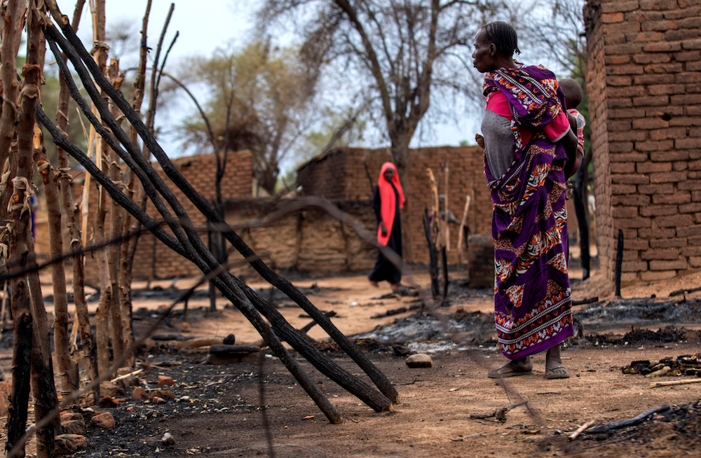 A woman looks at burnt houses during clashes between nomads and residents in Deleij village, located in Wadi Salih locality, Central Darfur, Sudan June 11, 2019. u00e2u20acu201d Reuters pic