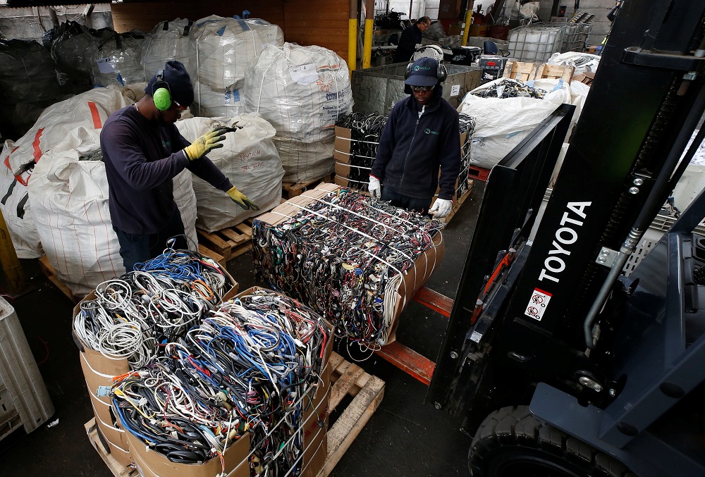 Employees move packs of electrical cable waste for transfer in a treatment plant for recycling of electronic products and papers in Santiago, Chile May 8, 2019. u00e2u20acu201d Reuters pic