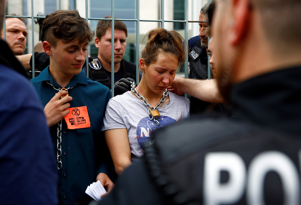 Police officers remove the chains of climate activists demonstrating outside the Chancellory in Berlin June 11, 2019. u00e2u20acu201d Reuters picnn