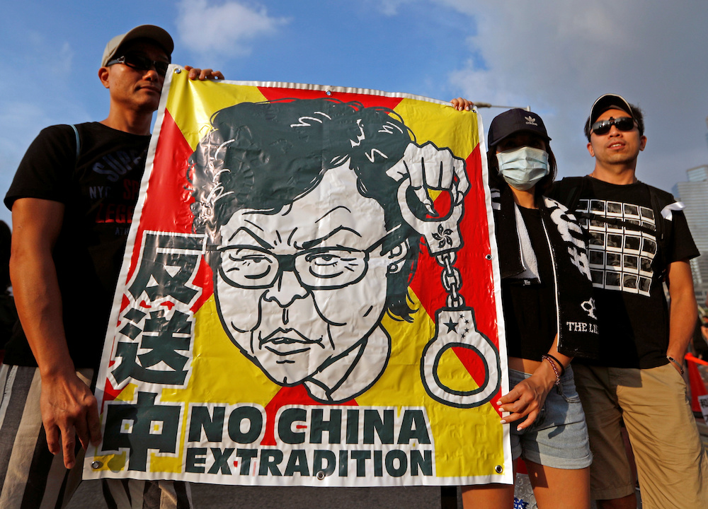 Protesters hold a placard as they attend a demonstration demanding Hong Kong's leaders to step down and withdraw the extradition bill, in Hong Kong June 16, 2019. u00e2u20acu201d Reuters picnn