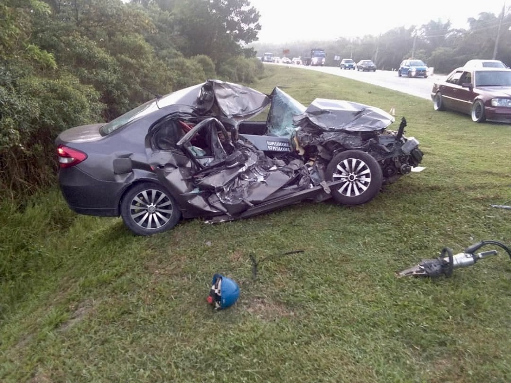 The badly damaged Proton Persona car that was earlier involved in an accident with a five-tonne lorry along Jalan Muar-Labis in Pagoh near Muar today. u00e2u20acu201d Picture courtesy of the Johor Fire and Rescue Department