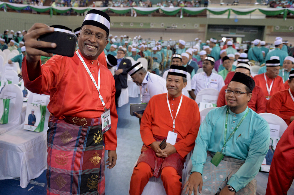 Datuk Seri Zambry Abdul Kadir takes a selfie with Datuk Seri Mohamad Hasan during the 65th PAS Muktamar in Kuantan June 21, 2019. — Picture by Mukhriz Hazim