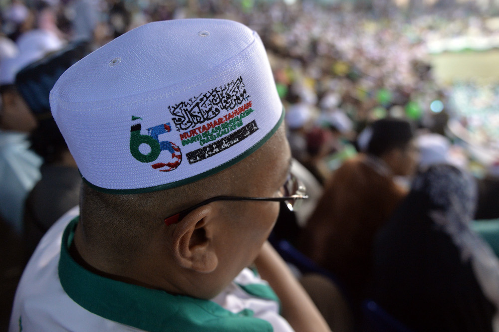 A PAS member listens to party president Datuk Seri Abdul Hadi Awang’s opening remarks during the 65th PAS Muktamar in Kuantan June 21, 2019. — Picture by Mukhriz Hazim