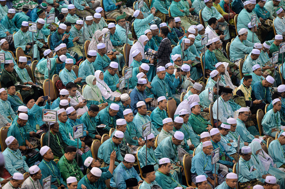 PAS members listen to party president Datuk Seri Abdul Hadi Awang’s opening remarks during the 65th PAS Muktamar in Kuantan June 21, 2019. — Picture by Mukhriz Hazim
