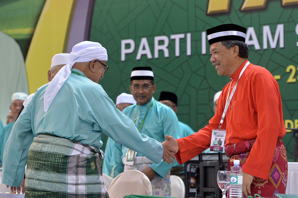 Datuk Seri Mohamad Hasan shakes hands with Datuk Seri Abdul Hadi Awang during the 65th PAS Muktamar in Kuantan June 21, 2019. u00e2u20acu201d Picture by Mukhriz Hazim