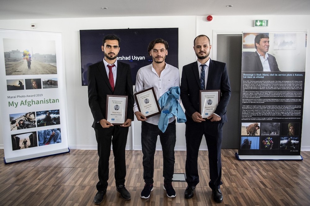 Afghan photographers (L-R) Mohammad Anwar Danishyar, Farshad Usyan and Hoshang Hashimi pose with their trophies after receiving the Marai Photo Award at Agence France-Presse (AFP) in Paris June 21, 2019. u00e2u20acu201d AFP picnn