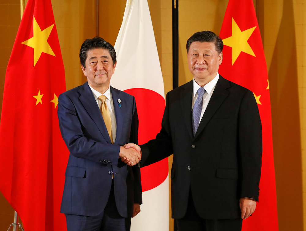 Chinese President Xi Jinping and Japanese Prime Minister Shinzo Abe shake hands at the start of talks at a hotel, prior to the G20 Summit at the International Exhibition Centre in Osaka June 27, 2019. u00e2u20acu201d Kimimasa Mayama/Pool handout via Reuters