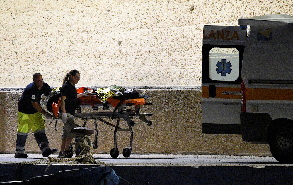 A migrant is helped by medical staff as he disembarks from the search and rescue ship Sea-Watch 3 at the island of Lampedusa June 27, 2019. u00e2u20acu201d Reuters pic