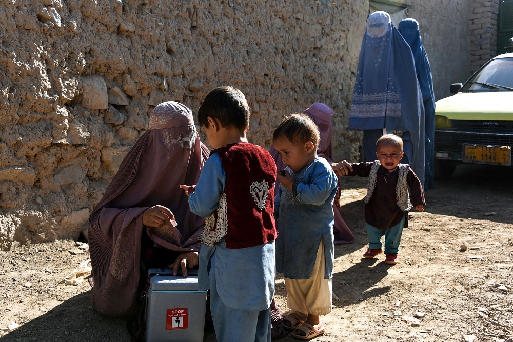 In this photo taken on March 20, 2019, Afghan health workers administer a polio vaccine to a child during a vaccination campaign in Kandahar province's Arghandab district. u00e2u20acu2022 AFP pic         