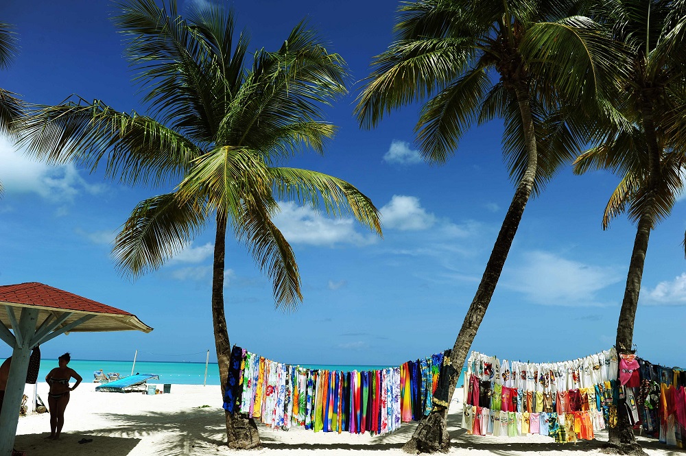 In this file photo taken on June 12, 2011, a vendor displays her colourful collection of clothing at a beach in St Johnu00e2u20acu2122s, Antigua and Barbuda. u00e2u20acu2022 AFP pic  