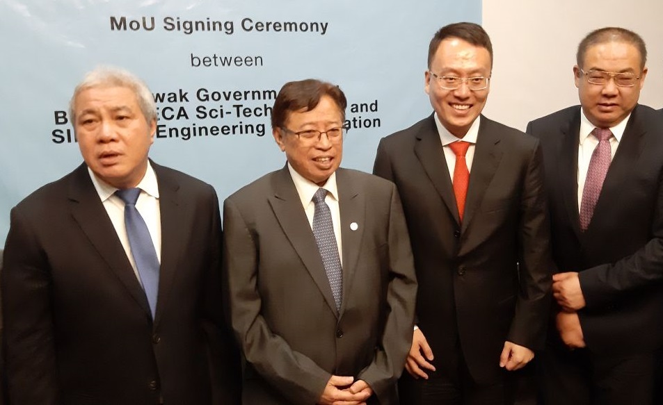 Chief Minister Datuk Abang Johari Openg (second from left) with Beijing BECA president Hao Liang (second from right) at the signing of the MoU June 10, 2019. u00e2u20acu201d Picture by Sulok Tawie