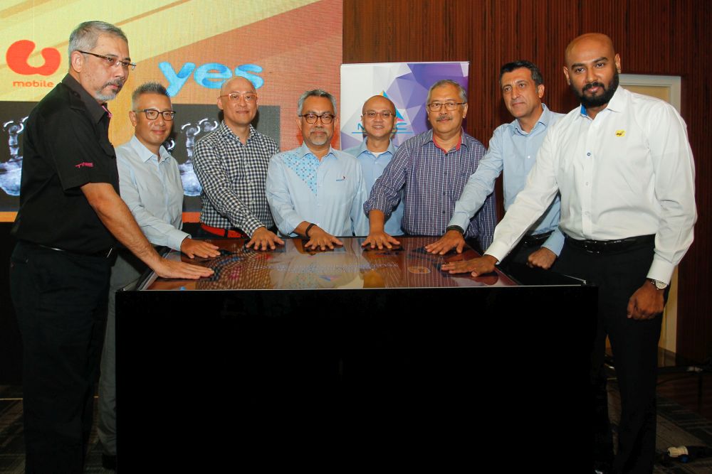 Malaysian Communications and Multimedia Commissions chairman Al-Ishsal Ishak (centre) poses for a group photo with telco CEOs in Putrajaya June 14, 2019. u00e2u20acu2022 Picture by Yusof Mat Isa