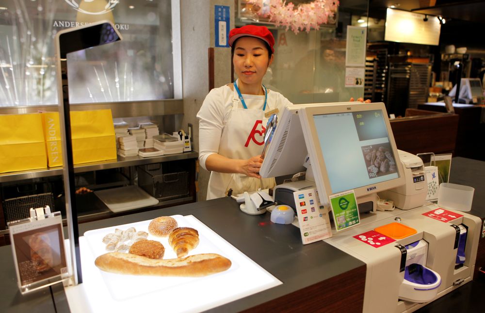 Pastry scanner: A worker at the Andersen bakery outlet at Ueno station in Tokyo uses a checkout scanner to calculate the price of pastries. u00e2u20acu201d Reuters pic