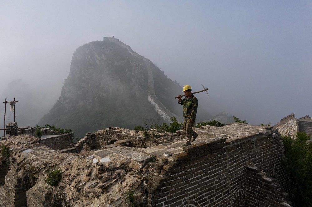 This picture taken on May 17, 2019 shows a worker inspecting at a restored part of the Great Wall in Xiangshuihu in Huairou District, on the outskirts of Beijing. u00e2u20acu2022 AFP pic  