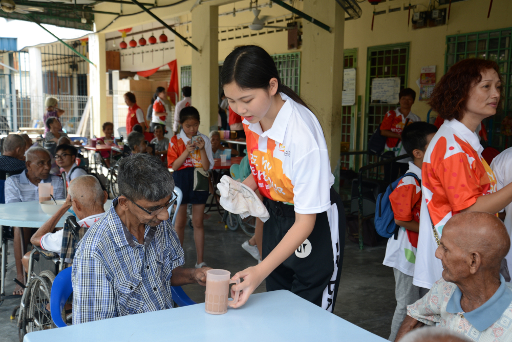 A volunteer serves breakfast to a resident at Sherun Old Folk Home & Handicap Centre. u00e2u20acu201d Picture courtesy of Country Garden Malaysia