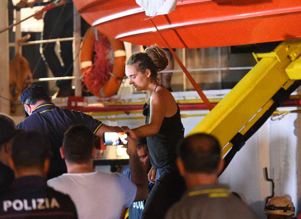 Carola Rackete, the 31-year-old Sea-Watch 3 captain, is escorted off the ship by police and taken away for questioning, in Lampedusa, Italy June 29, 2019. u00e2u20acu2022 Reuters pic